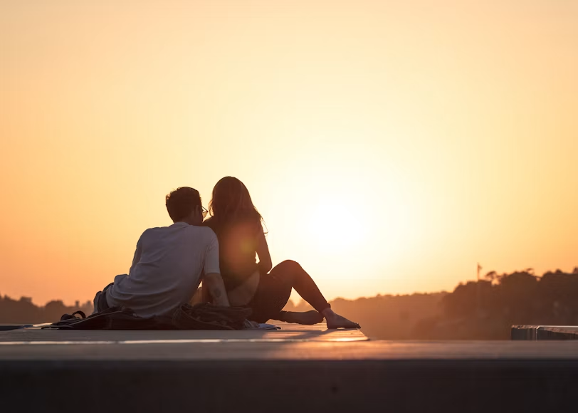 Couple sitting together at sunset — Hardwired For Pleasure intimacy and connection goals